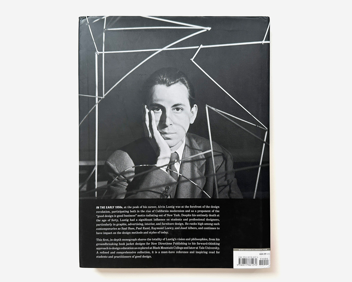 Book cover with a black and white portrait of Alvin Lustig and geometric design elements.